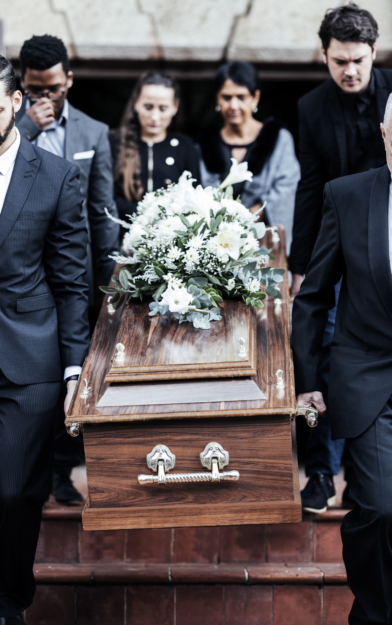 Death, funeral and people with coffin to cemetery, graveyard and morgue for burying, cremation or r